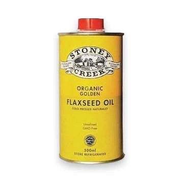 A 500ml yellow metal can of Stoney Creek Organic Golden Flaxseed Oil with a red cap, shown on a plain white background.